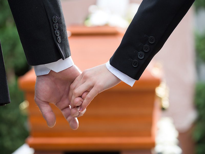 Holding hands at a funeral